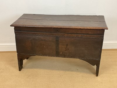 Lot 813 - An 18th century oak plank coffer with carved...