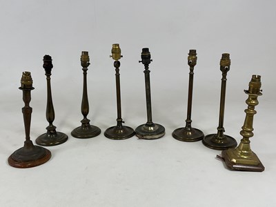 Lot 724 - Eight early 20th century brass table lights,...