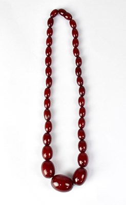 Lot 635 - A cherry amber-coloured bead necklace of...