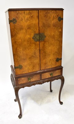 Lot 56 - A mid-20th century walnut drinks cabinet with...