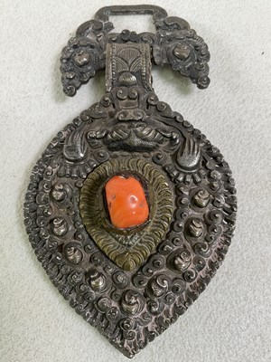 Lot 1508 - A Nepalese white metal buckle applied with a...