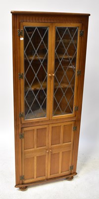 Lot 10 - A reproduction corner cupboard with leaded...