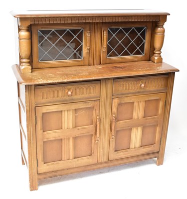 Lot 24 - An Ercol-style elm court cupboard with a pair...