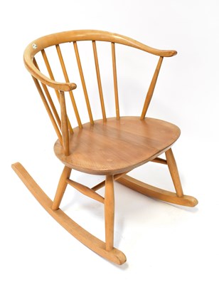 Lot 20 - ERCOL; a light elm rocking chair with...