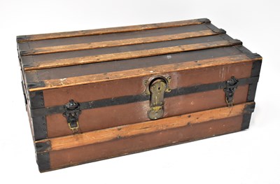 Lot 52 - A wooden and metal bound banded trunk with...