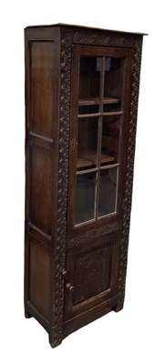 Lot 58 - A reproduction carved oak narrow bookcase,...