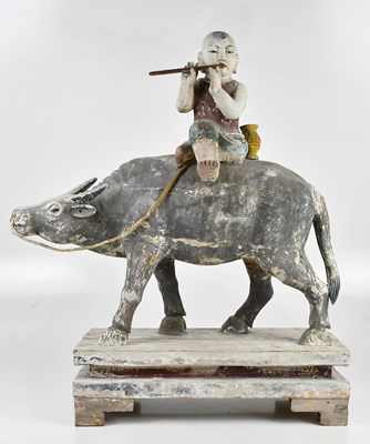 Lot 1014 - A 19th century painted wood sculpture of a boy...