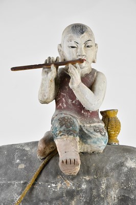 Lot 1014 - A 19th century painted wood sculpture of a boy...
