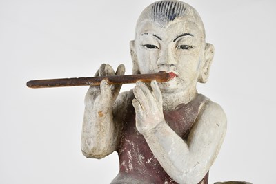 Lot 1014 - A 19th century painted wood sculpture of a boy...