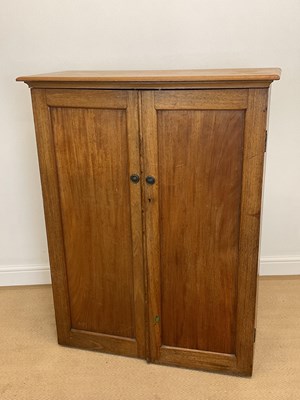 Lot 854 - A two door pine cupboard with two internal...