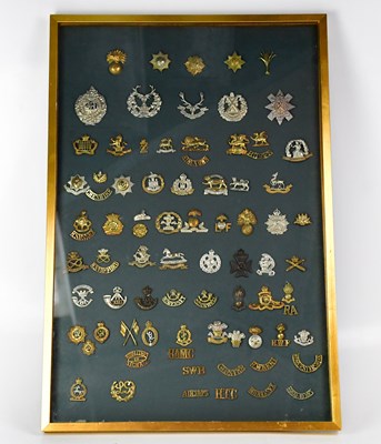 Lot 420 - A framed montage of military cap badges to...