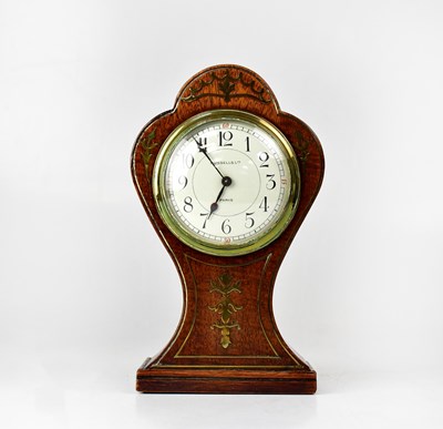 Lot 348 - A balloon-shaped mantel clock with brass inlay,...