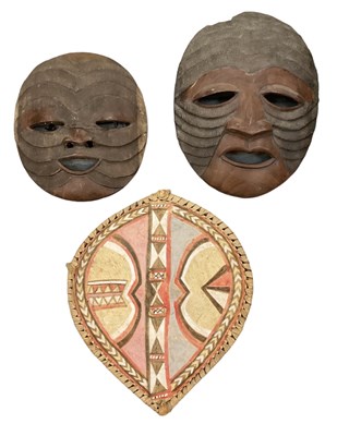 Lot 1102 - Two African carved wooden wall hanging masks,...