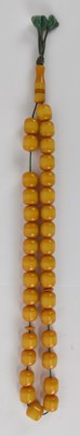 Lot 1252 - A butterscotch amber bead necklace, length...