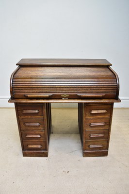 Lot 141 - An early 20th century oak roll top desk, with...