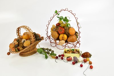 Lot 313 - A wicker basket with waxed fruit centrepiece,...