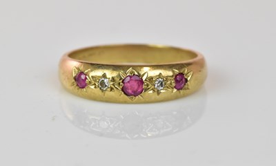 Lot 1069 - A 9ct yellow gold ruby and diamond five stone...