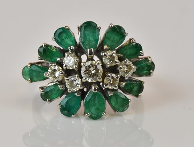 Lot 1230 - An 18ct white gold emerald and diamond cluster...