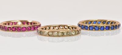 Lot 1223 - Three yellow metal dress eternity rings, sizes...