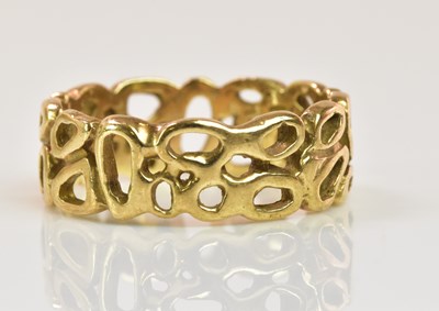 Lot 1205 - An unusual pierced 9ct yellow gold band ring,...