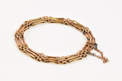 Lot 1206 - A 9ct yellow gold three bar gate link bracelet,...