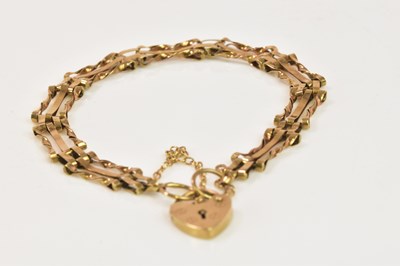 Lot 1209 - A 9ct yellow gold bracelet with padlock clasp,...