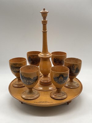 Lot 22 - MAUCHLINE WARE; a six setting egg cruet frame...