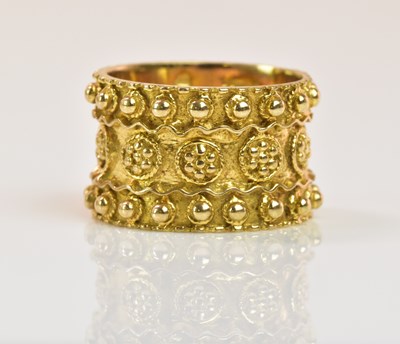 Lot 1295 - A broad textured 9ct yellow gold band ring,...