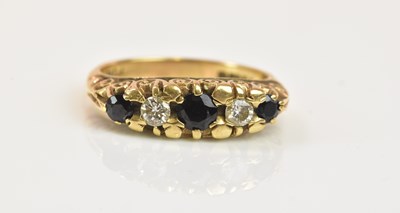 Lot 1296 - A 9ct yellow gold five stone sapphire and...