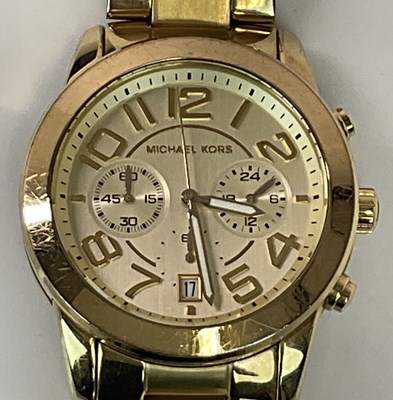 Lot 1380 - MICHAEL KORS; a gentleman's gold tone...