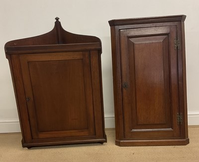 Lot 817 - A mahogany wall hanging corner cabinet, with a...