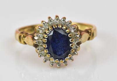 Lot 1238 - A 9ct gold sapphire and diamond oval cluster...