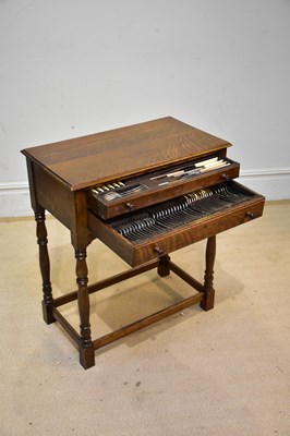 Lot 564 - An early 20th century oak two drawer table...