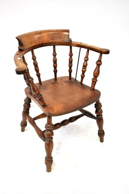 Lot 11 - An early 20th century oak captain's chair