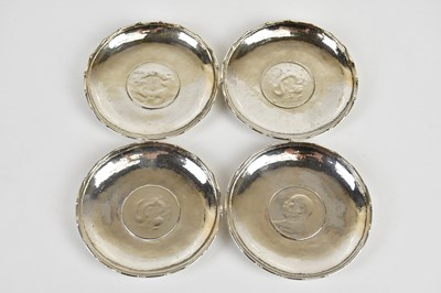 Lot 1029 - A set of four Chinese silver coin set dishes,...