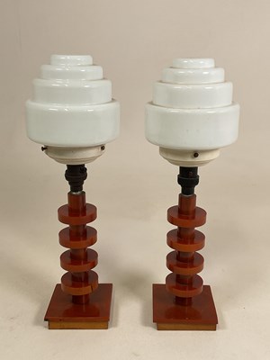 Lot 720 - A pair of amber bakelite Art Deco lamps with...