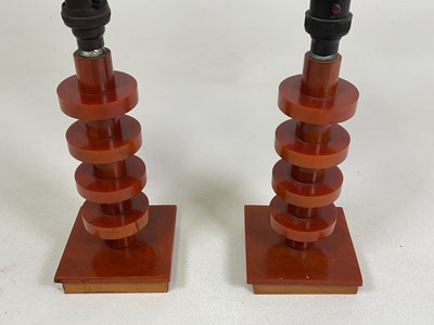 Lot 720 - A pair of amber bakelite Art Deco lamps with...