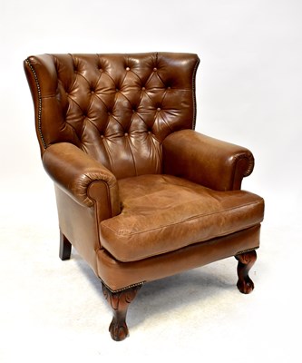 Lot 12 - A mid-20th century conker brown leather Chesterfield wing back chair