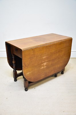 Lot 78 - A reproduction oak drop-leaf gateleg dining...