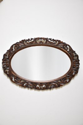 Lot 205 - An early 20th century carved oak oval wall...