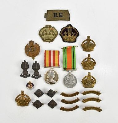 Lot 1301 - A collection of medals and cap badges...