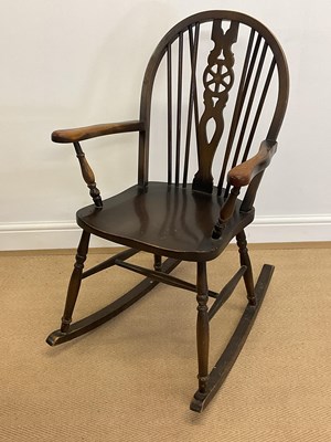 Lot 878 - A reproduction Windsor wheel back stained...