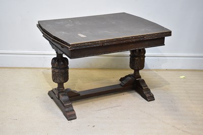 Lot 164 - A 1920s oak draw-leaf dining table on carved...