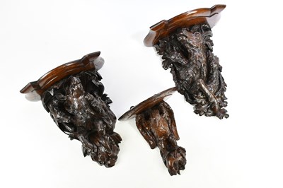 Lot 299 - Three Black Forest carved oak wall brackets,...