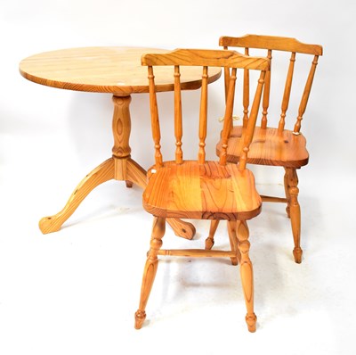 Lot 35 - A contemporary circular pine kitchen table to...