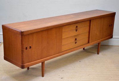 Lot 7 - A mid century teak sideboard with two sliding...