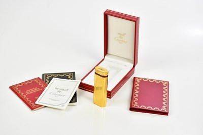 Lot 319 - MUST DE CARTIER; a boxed lighter, with booklet.