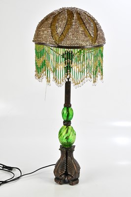 Lot 392 - A modern green glass and copper lamp, with...