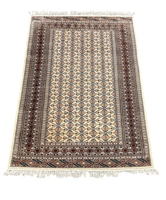 Lot 86 - A Persian hand woven cream ground carpet with...