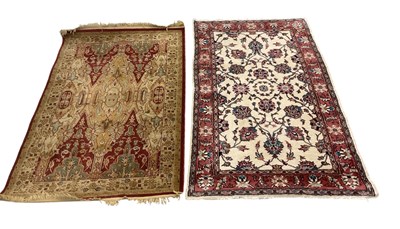 Lot 91 - A modern red ground machine woven carpet, 185...